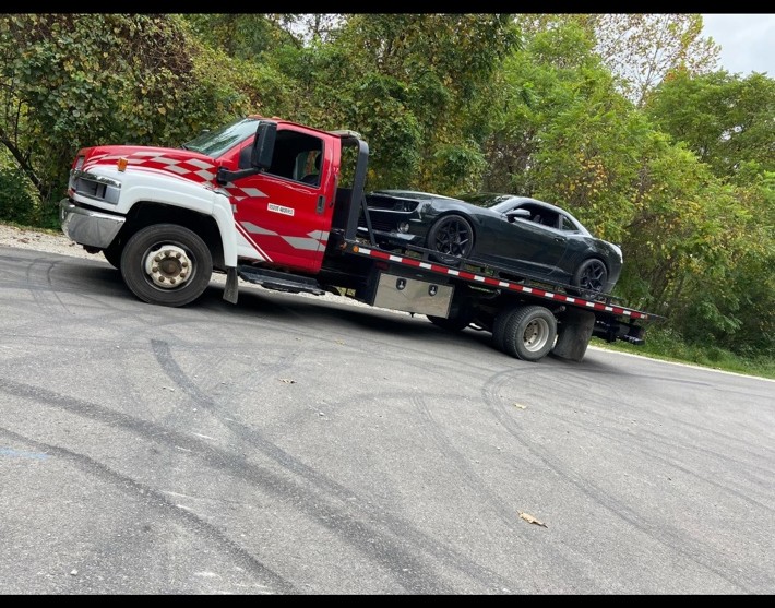 Carmon's Towing transporting a sports car
