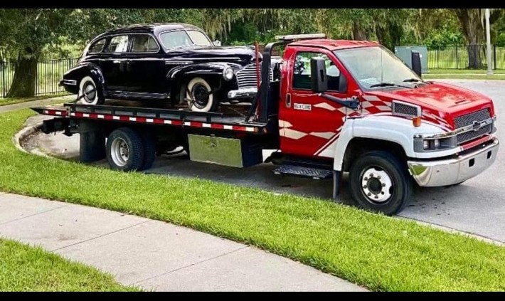 Carmon's Towing transporting a classic car